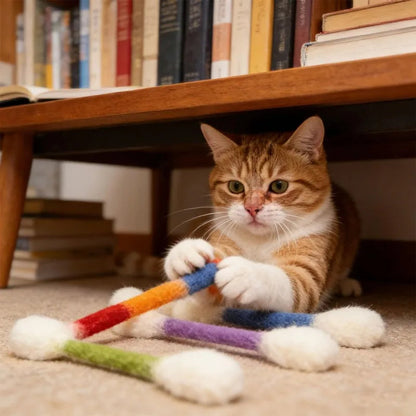 Cat beside colorful PurrSwab kicker toys